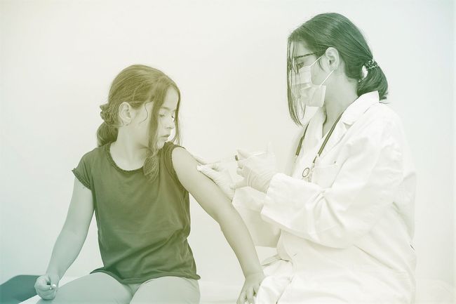 Pediatrician gives vaccination to patient