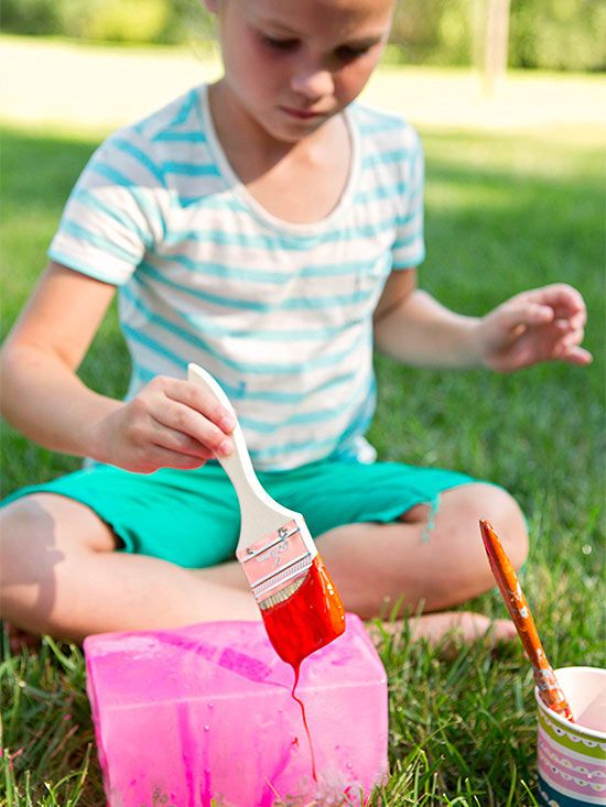 Girl painting block of ice